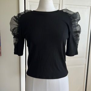 Black top with pouf sleeves.